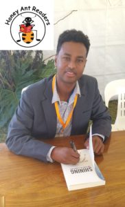 Abdi Aden signs his book for HARs.